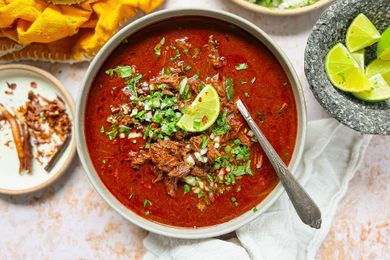 Birria in a bowl garnished with a lime wedge 