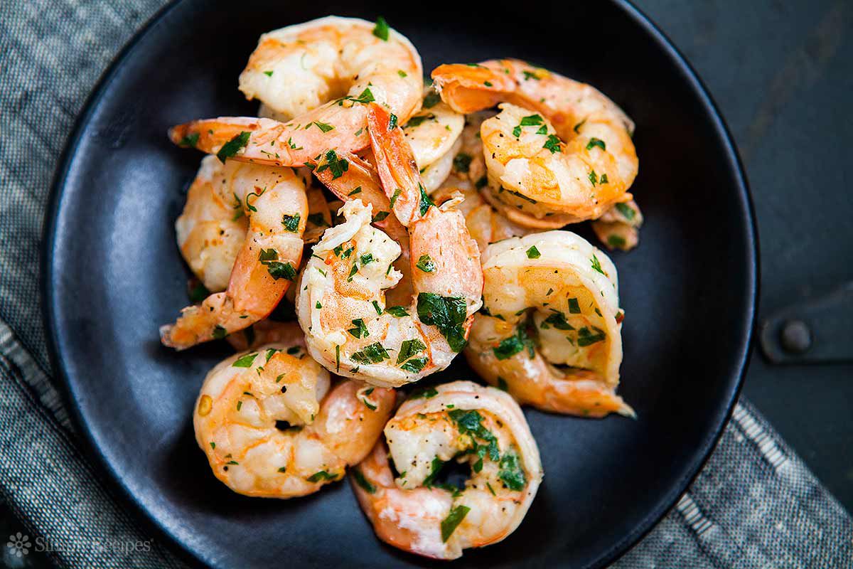 shrimp scampi in a black bowl