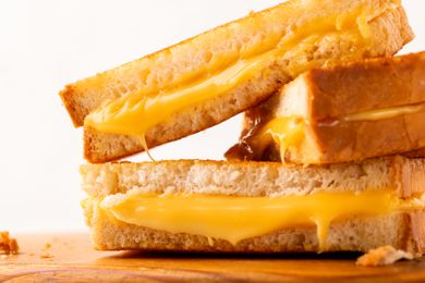 grill cheese sandwich with melty cheese coming out the edges