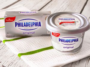 Philadelphia cream cheese (box and container, side by side) on the counter