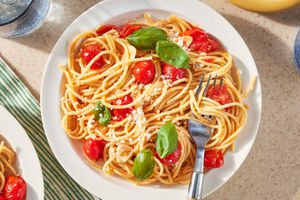 plateful of pasta with cherry tomatoes and basil leaves