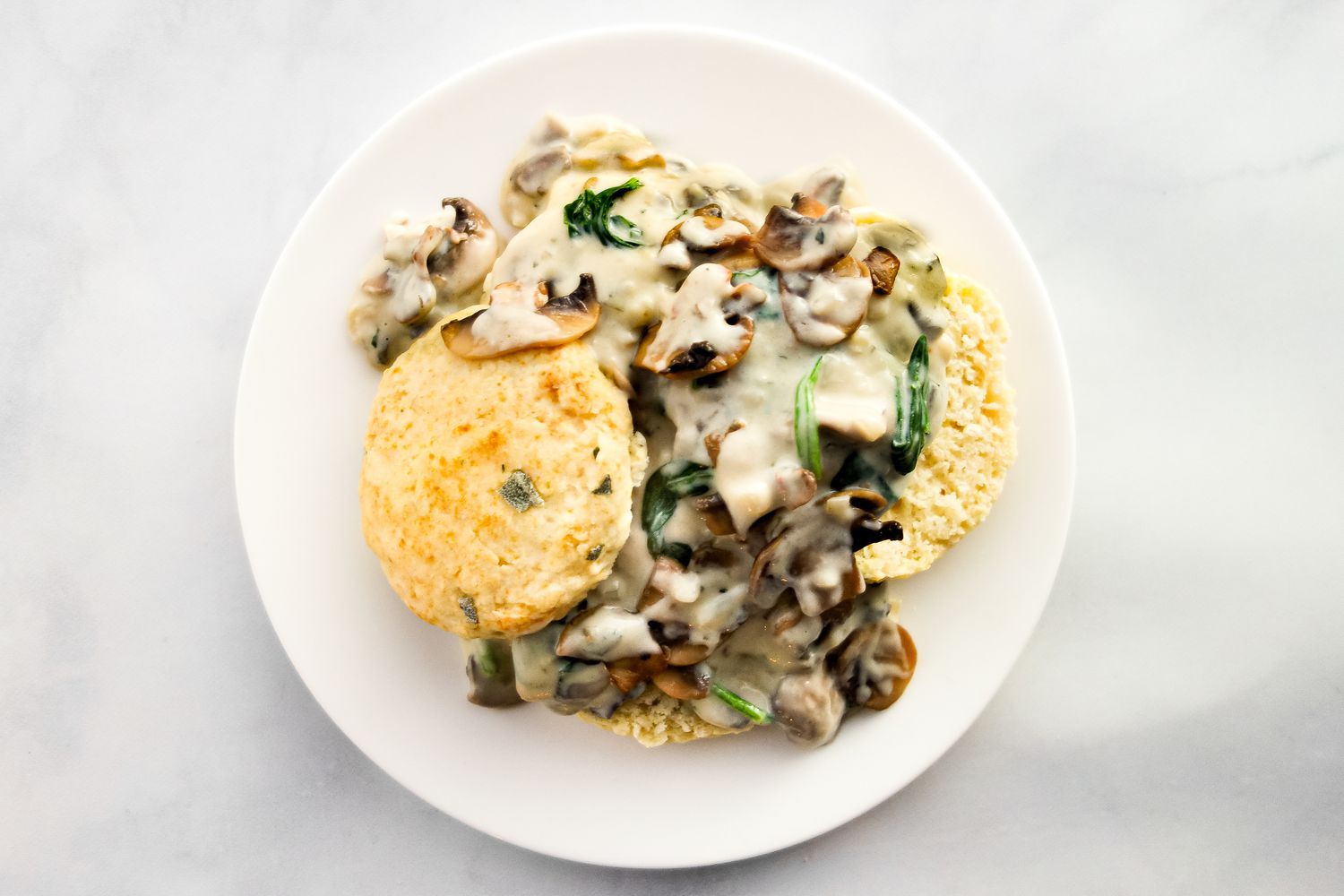 Vegetarian biscuits and gravy on a white plate.