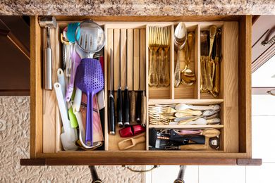 A kitchen drawer full of utensils and tools