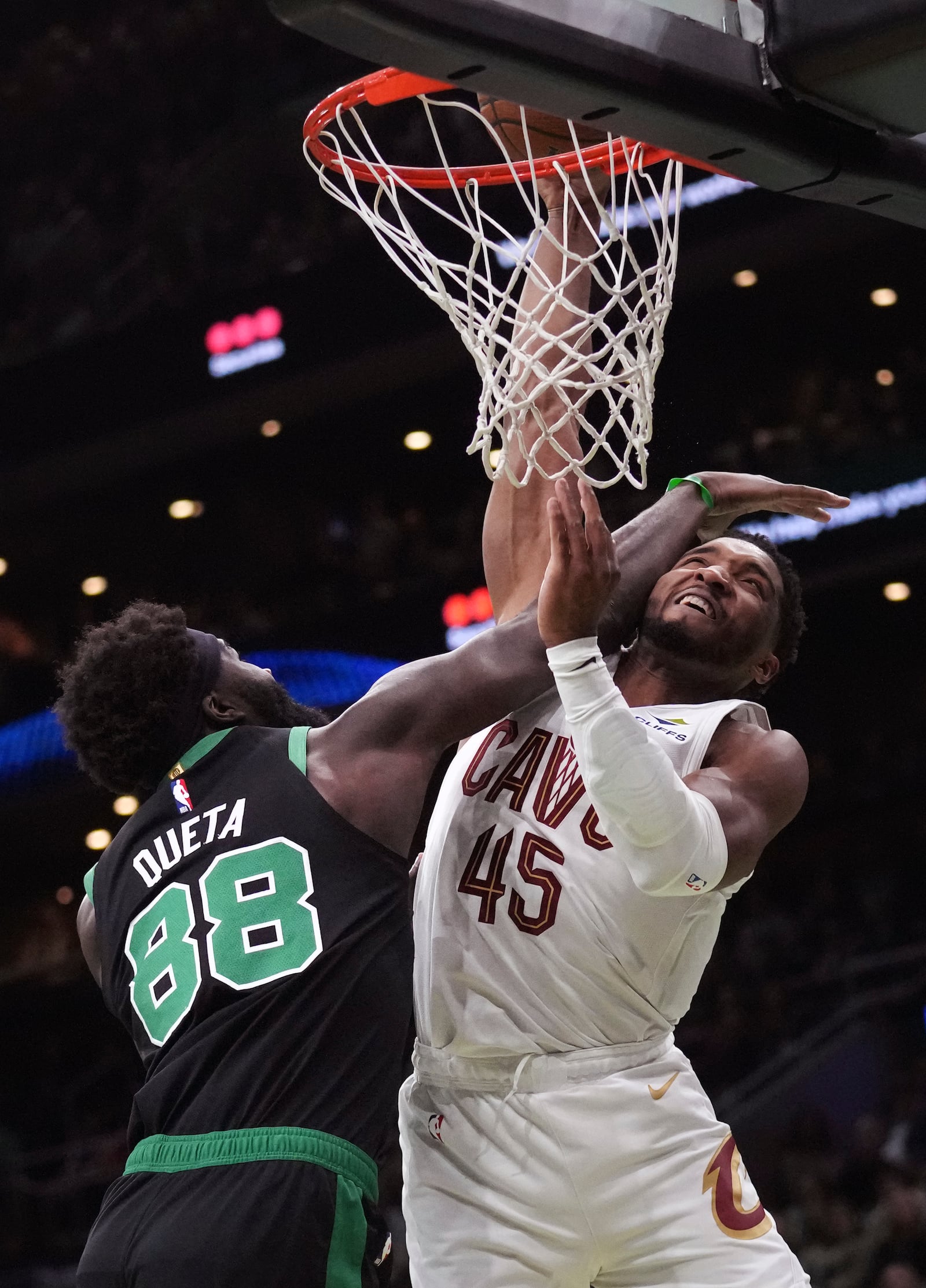 Boston Celtics center Neemias Queta (88) fouls Cleveland Cavaliers guard Donovan Mitchell (45) on a drive to the basket during the first half of an Emirates NBA Cup basketball game, Tuesday, Nov. 19, 2024, in Boston. (AP Photo/Charles Krupa)