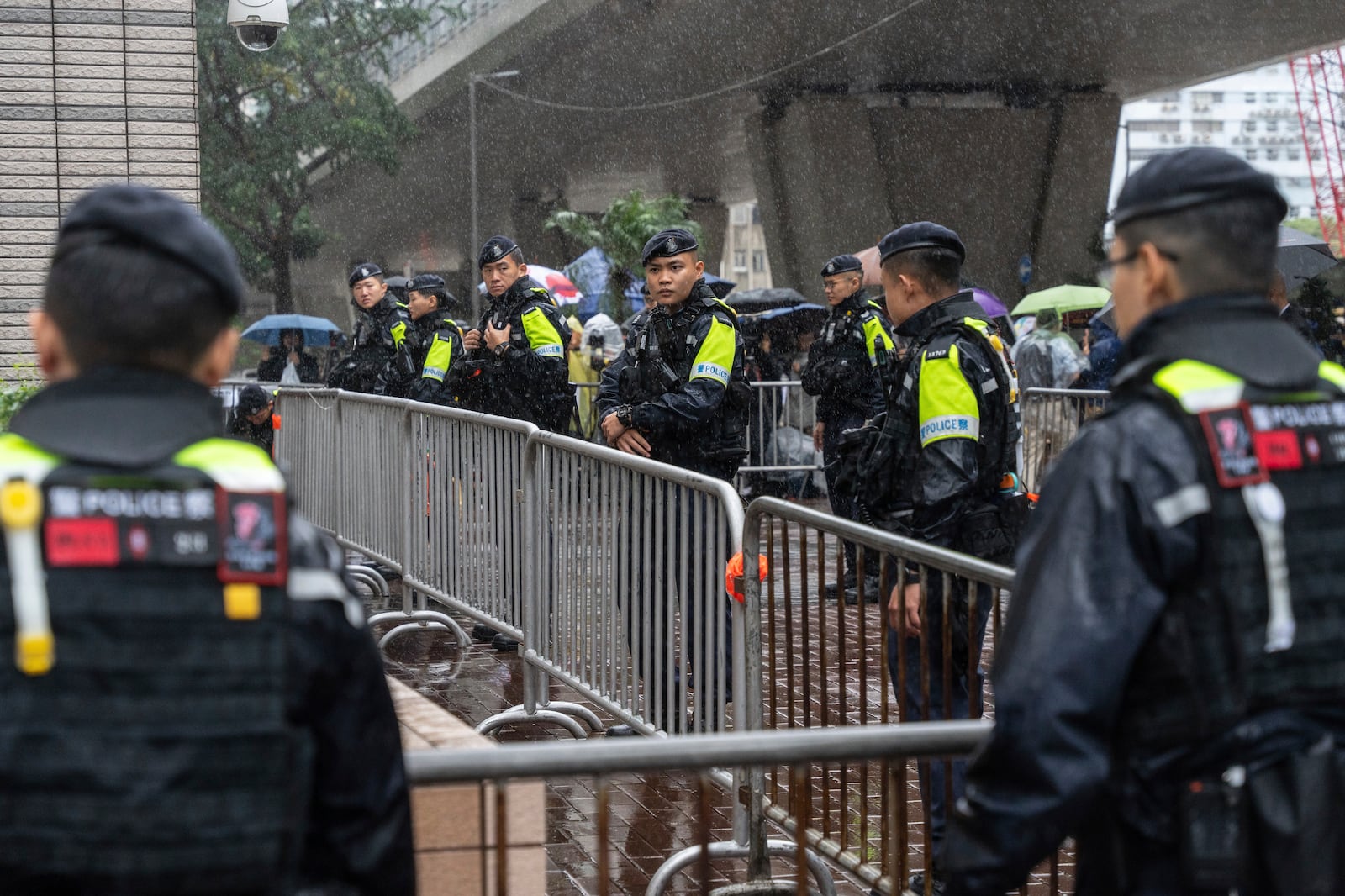 Police stand guard outside the West Kowloon Magistrates' Courts in Hong Kong, Wednesday, Nov. 20, 2024. (AP Photo/Chan Long Hei)