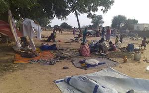 Residents displaced from a surge of violent attacks squat on blankets and in hastily made tents in the village of Masteri in west Darfur, Sudan, on July 30, 2020.