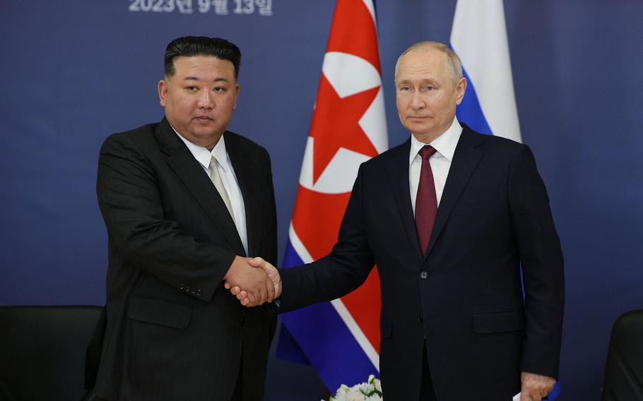 Russian President Vladimir Putin, right, and North Korea’s leader Kim Jong Un shaking hands