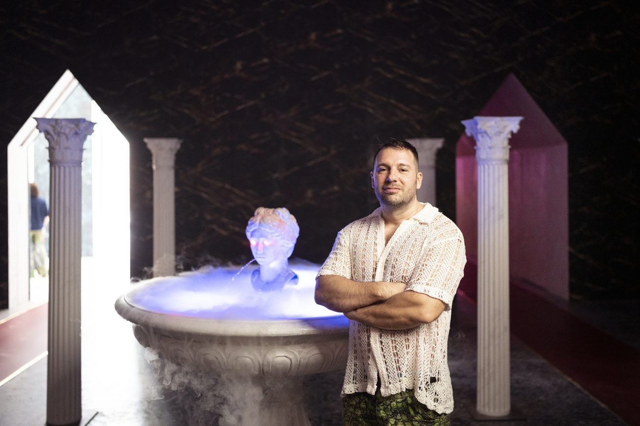 Guerreiro do Divino Amor poses in front of the "Fountain of Helvetia", part of the installation at the Swiss Pavilion in Venice.