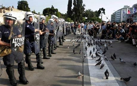We can take no pleasure from the euro's fall; Riot police guard Greece's parliament in Athens; EPA