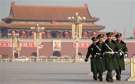 Paramilitary guards walk on a closed-off Tiananmen Sqaure, near the Great Hall of the People, prior to the unveiling of a new Politburo Standing Committee in Beijing on November 15, 2012.  