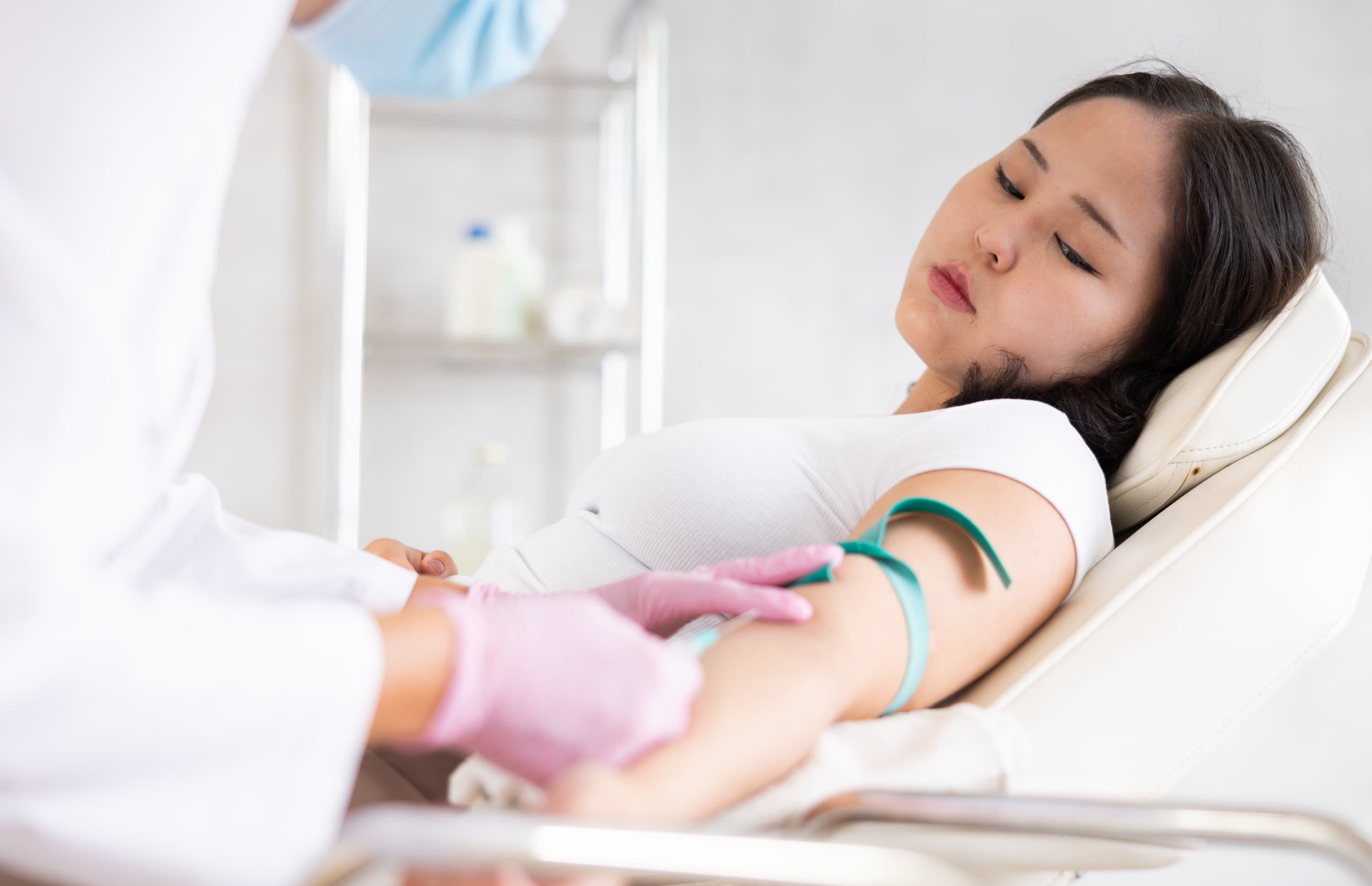 A woman undergoes a blood test at her doctor's office to check her bad cholesterol levels because she's worried about heart disease.