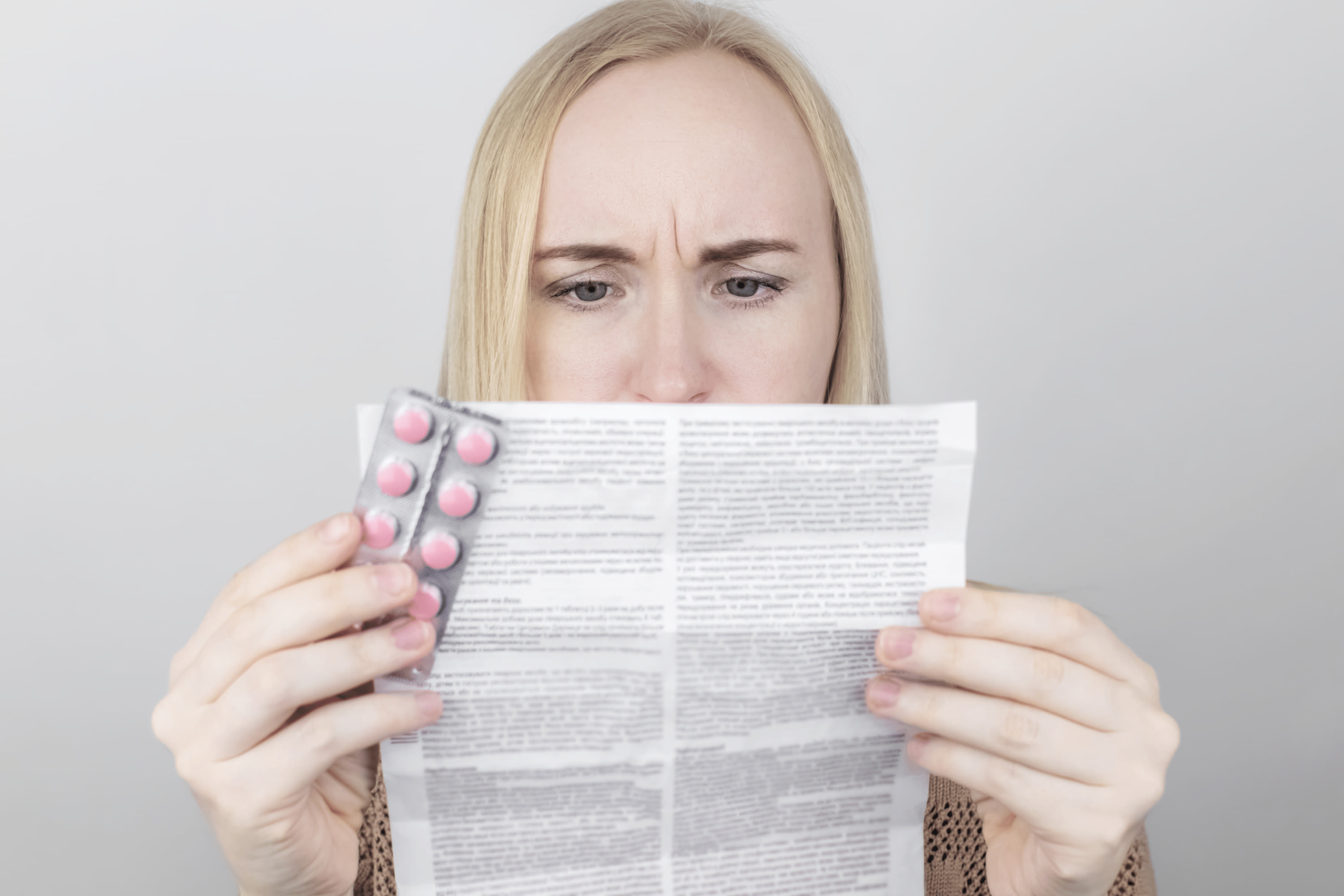 Woman reads the new FDA warning about prescription drug Veozah (fezolinetant).