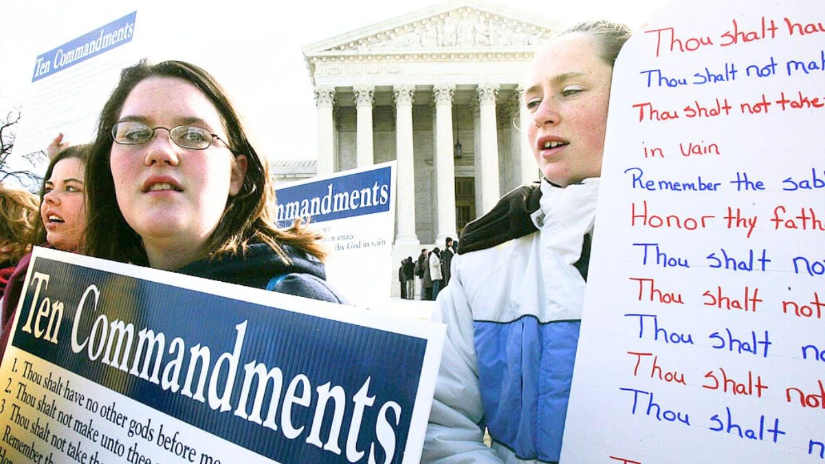 WASHINGTON - MARCH 2: Anna Dollar (2nd L) of Boone, NC, and Deanna Gosnell (R) of Avery, North Carolina, hold posters during a rally in front of the U.S. Supreme Court to support the Ten Commandments March 2, 2005 in Washington, DC. The Supreme Court heard two cases on whether Ten Commandments monuments should be displayed on government properties. (Photo by Alex Wong/Getty Images)