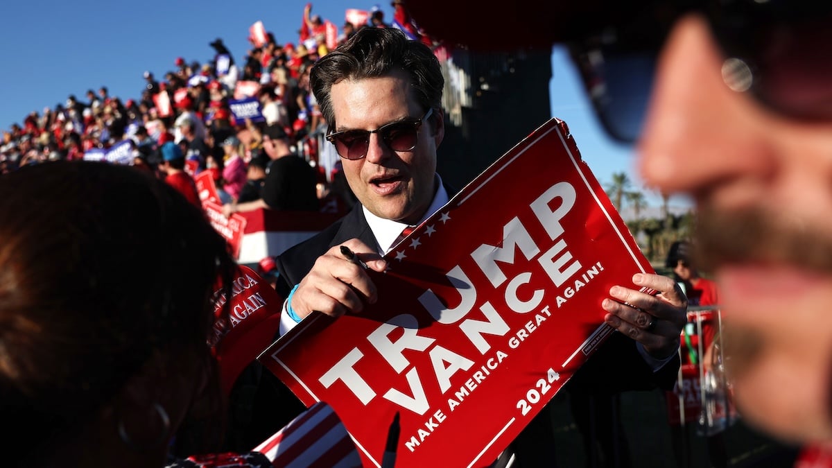 matt gaetz holding a yard sign