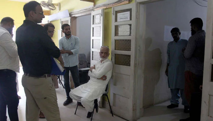 Social worker Sarim Burney is seen seated ahead of his hearing of a case against him pertaining to human trafficking at the city court in Karachi on June 6, 2024. — PPI