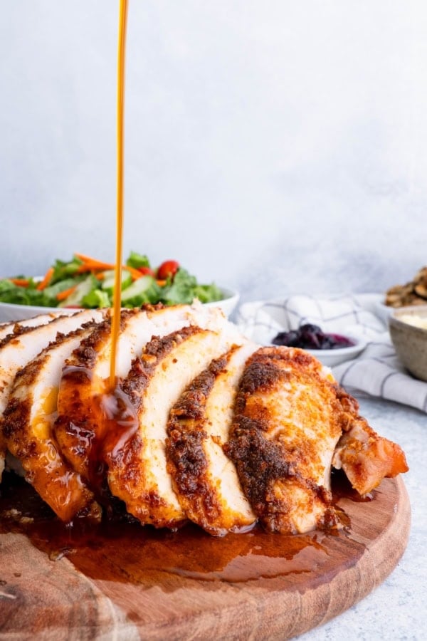 Gravy being poured on Garlic Butter Turkey Breast.