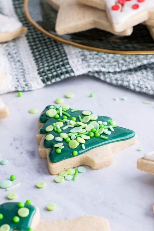 gluten-free sugar cookies on a marble surface, decorated into Christmas shapes.