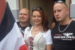 Angela Schaller, posing with neo-Nazis and the black, white and red flag of the German Reich