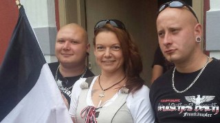 Angela Schaller, posing with neo-Nazis and the black, white and red flag of the German Reich