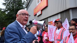 Dave Ward, general secretary of the Communications Workers Union, speaks to Royal Mail strikers on a picket line in London in 2022