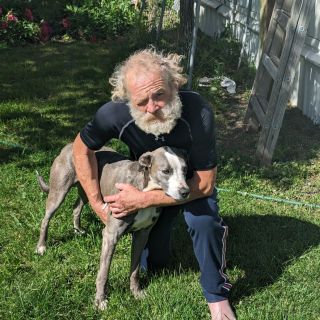 Brandon Garrett with his two-year-old whippet, Blue. The dog’s pluck saved his life after a crash on a remote road