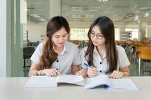two girls studying