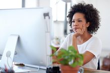 woman focuses on computer screen