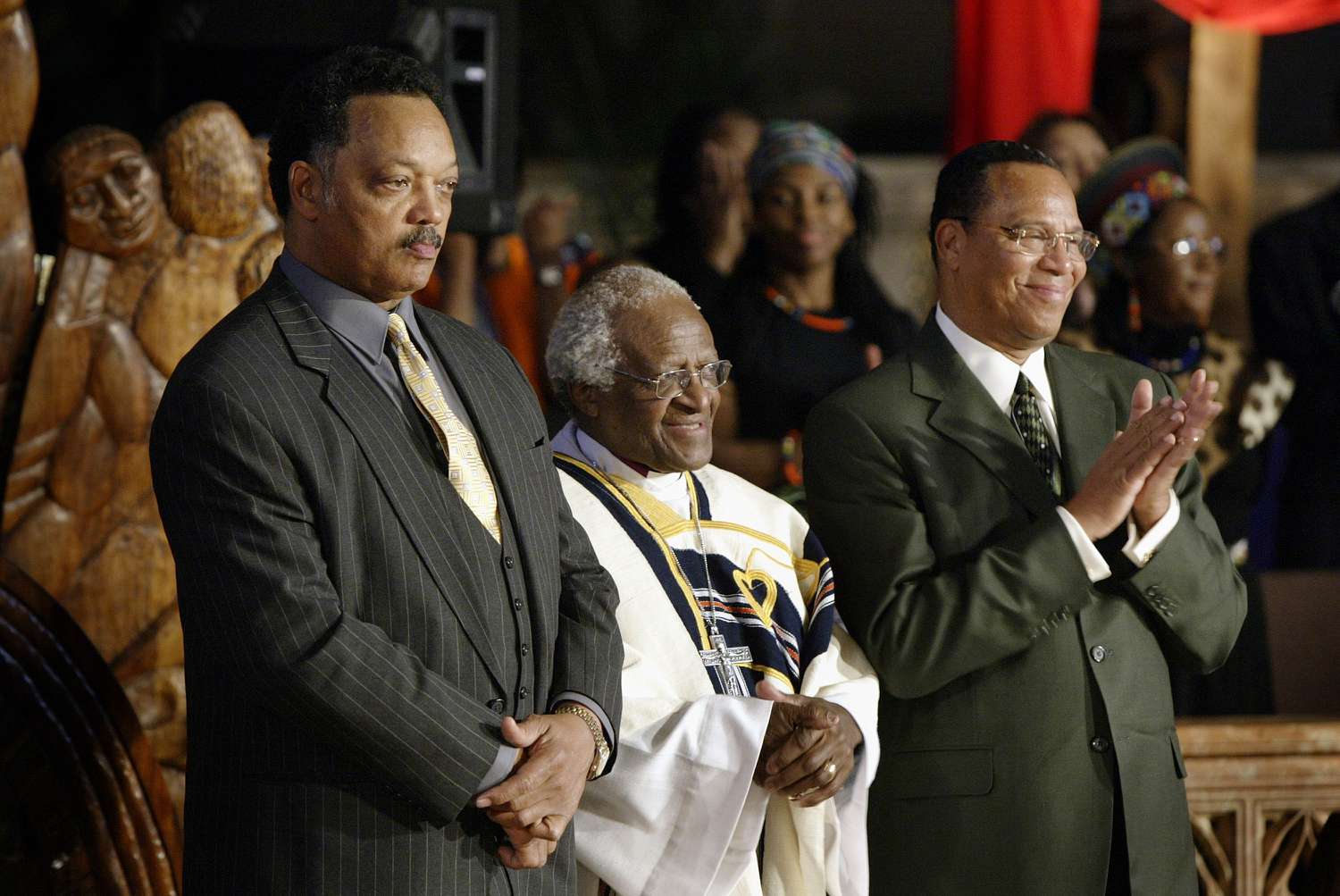 Rev. Jesse Jackson, Archbishop Desmond Tutu, and Minister Louis Farrakhan standing together