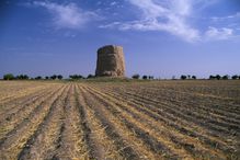 A Buddhist stupa rises over a field in Uzbekistan