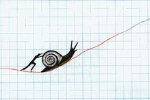 Man pushing snail up slowly ascending line on graph