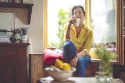 Mature woman is having the morning coffee at home