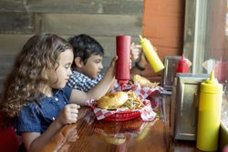 Children having burgers in restaurant