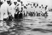 Followers of Gandhi fill plastic bottles with seawater during the Salt March of 1930 in India, to protest British colonial salt taxes.