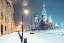 Night view of the Red Square and St. Basil Cathedral in Moscow during snowstorm