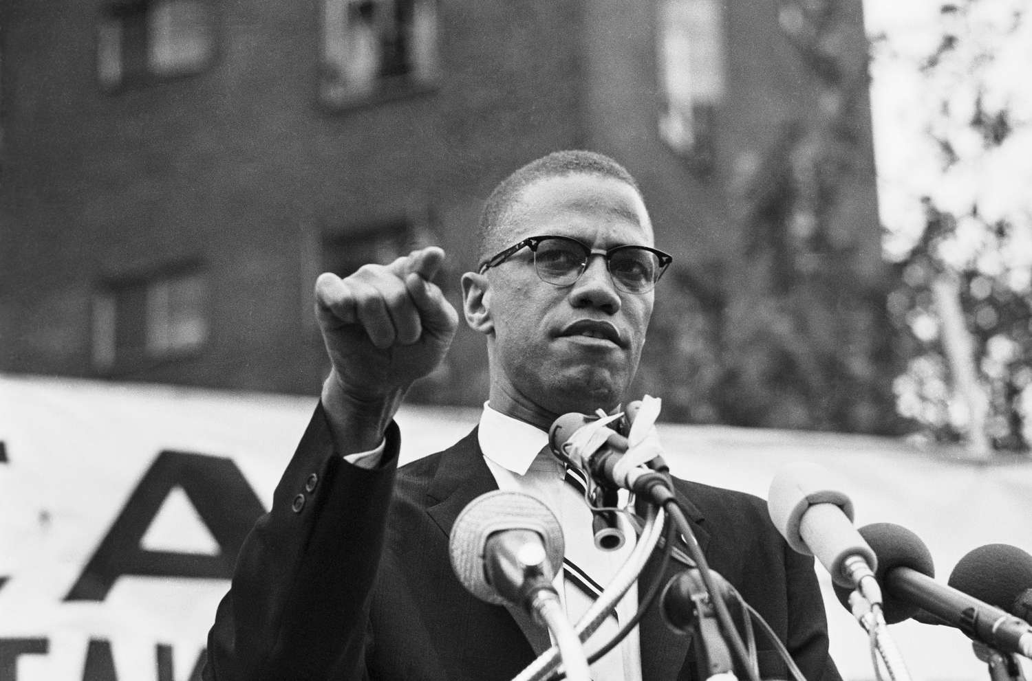 Malcolm X points finger and frowns during speech