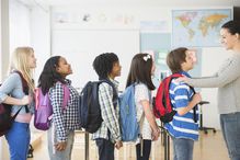 Teacher in front of row of students in classroom