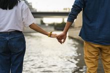 France, Paris, couple holding hands at river Seine