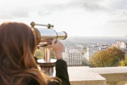 Woman looking through telescope