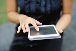 Woman's hands with a tablet computer