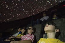 A picture of kids enjoying a field trip at a planetarium