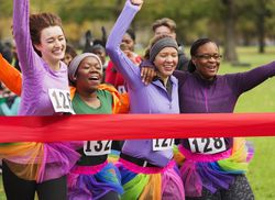 Four women crossing the finish line in a race.