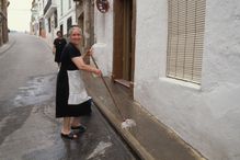 Woman Cleaning Sidewalk in Spain