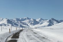 Endless mountain road through winter landscape