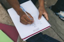 Young man taking notes on Spanish language