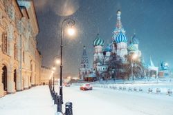 Night view of the Red Square and St. Basil Cathedral in Moscow during snowstorm