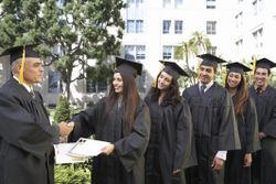 Dean presenting graduate students with awards outside college