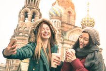 Happy girlfriends taking winter selfie in Saint Petersburg Russia