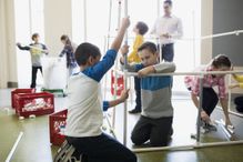 Students assembling model pipeline in science center