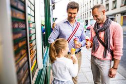 Fathers enjoying ice cream with daughter