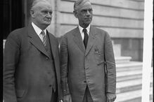 A black and white photo of two men in 1920s business suits